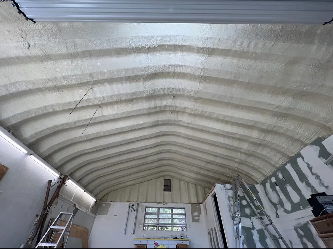 Spray polyurethane foam applied to the underside of a metal roof deck in Winton